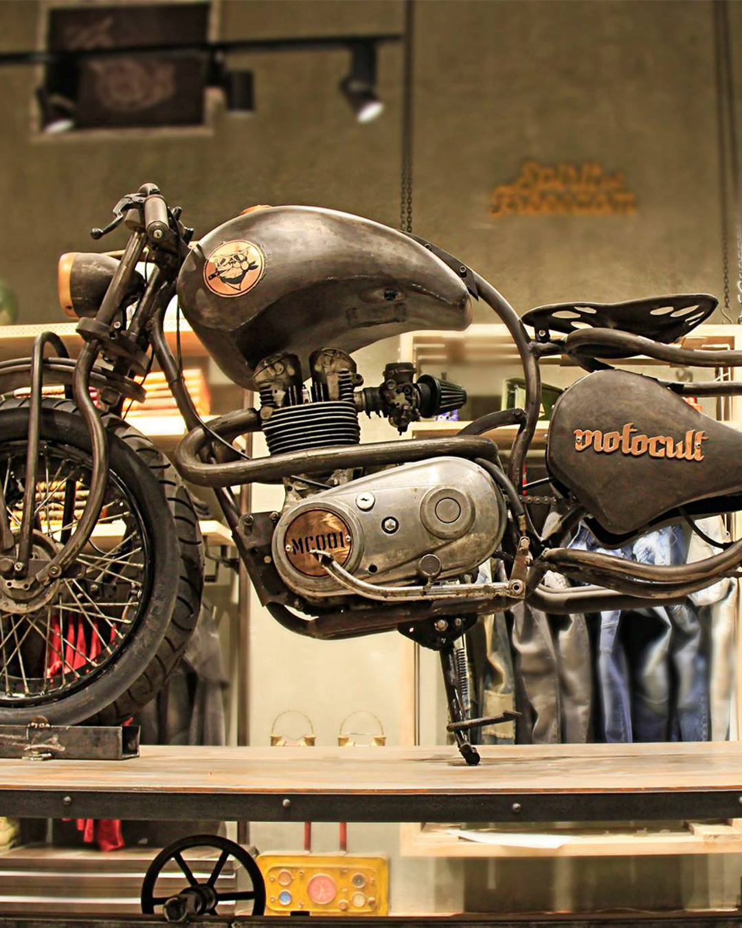 Branded retail environment showcasing an industrial motorcycle display as part of a retail identity and in-store storytelling concept by JUMPINGGOOSE.