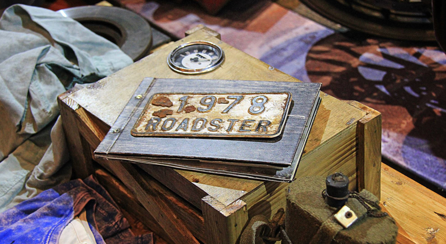Roadster 1978 metal plaque styled as a retail display prop, highlighting visual merchandising and brand storytelling details.