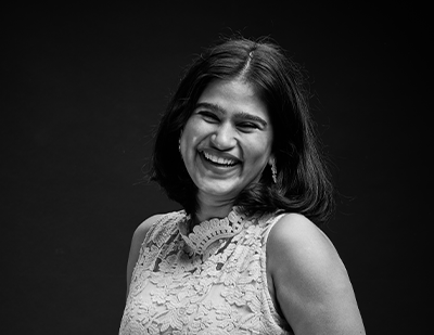 Studio-style black-and-white photograph of Elizabeth captured mid-laughter, alongside a high-contrast name card stating 'Elizabeth – Stylish Siren'.
