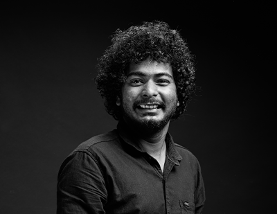 Studio-lit black-and-white photograph of Hemin, captured mid-smile, alongside a contrasting title frame displaying 'Hemin – The MP4-ger'.