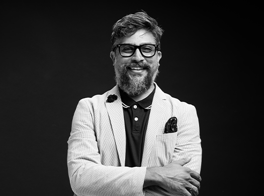 Black-and-white portrait of Piyush, labeled 'The Rain Maker,' showing him smiling with folded arms, paired with a bold title slide introducing his name and role.