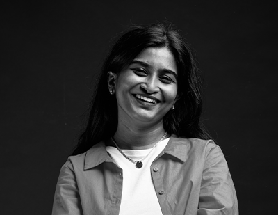 Editorial-style black-and-white photograph of Ray smiling with folded arms, combined with a graphic overlay naming her 'Ray – The Brand Ray-dar'.