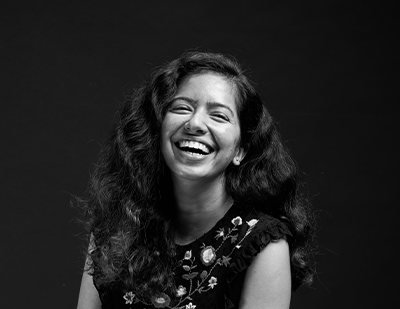 Black-and-white portrait of Shailja smiling against a dark background, paired with a graphic title card reading 'Shailja – The Trend Oracle'.