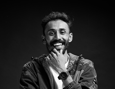 Black-and-white portrait of Theo smiling thoughtfully, paired with a bold title card reading 'Theo – The Design Doctor', presenting his creative leadership persona.