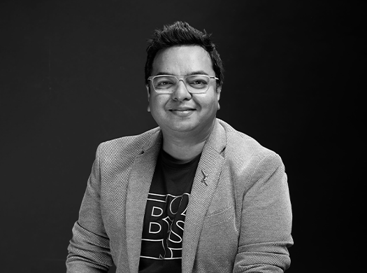 Monochrome portrait series of Tuhin, showing a friendly seated studio photograph and a stylized text-led version with 'TUHIN – The Dreamweaver,' reflecting creative vision and thought leadership.